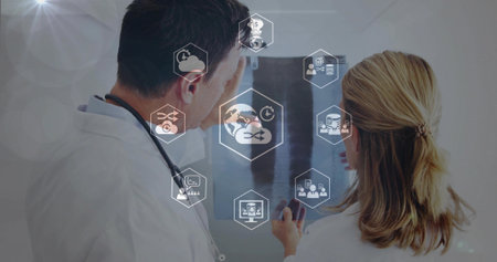 Reviewing two doctors in white coats holding X-ray at clinic with stethoscope and IT icons....