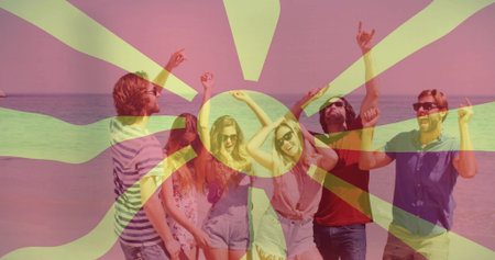 Cheering six friends raising arms at beach, wearing summer clothes, sunglasses, sunburst overlay....