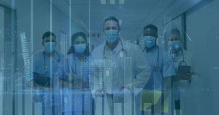 Standing team wearing scrubs and masks in clinic corridor, holding stethoscopes, chart overlays....