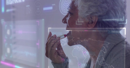 Applying lipstick, senior woman looking at mirror at vanity in gray cardigan, HUD, copy space....