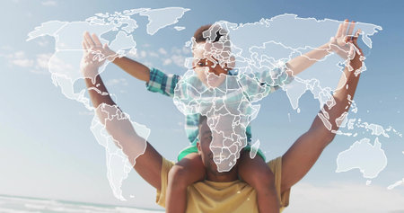 Man carrying boy on shoulders at beach wearing yellow tee plaid shirt sunglasses world map overlay....