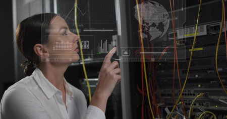 Pointing tech in white shirt using hologram UI at server aisle, yellow orange cables, copy space....