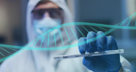 Presenting tech in hooded coverall with gloved hand holding specimen tube at lab with DNA overlay....