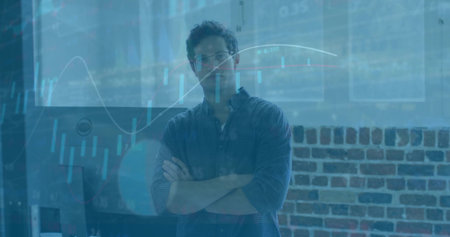 Posing man wearing blue checked shirt glasses crossing arms in office with screen and chart overlay....