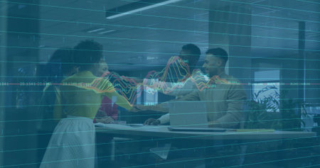 Working office team, woman wearing yellow top leaning, pointing at laptop with chart overlay....