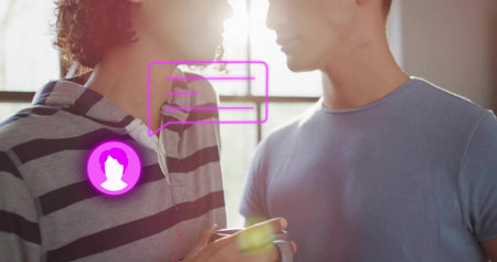 Holding striped hoody cradling mug, facing blue tee partner in sunlit room by window, magenta icon....