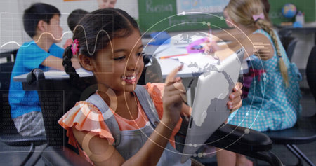 Holding tablet, schoolgirl in pinafore using stylus in classroom, with globe and digital charts....