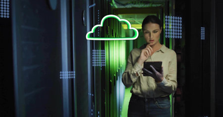 Inspecting server racks IT technician in beige shirt and jeans holding tablet, with cloud overlay....