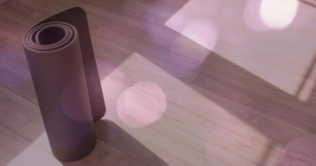 Standing rolled dark yoga mat casting long shadow on plank floor, window shadows, bokeh, copy space. Pad, fitness, stretch, studio, sunlight, flare, minimalistの写真素材