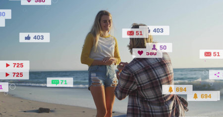 Man kneeling proposing offering ring on shore, activating rising social media alerts showing counts....