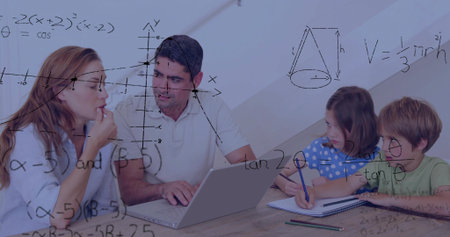Teaching family of four studying math at wooden table, using laptop, notebooks and math overlays....