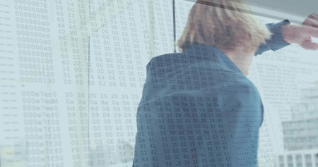Pointing man in blue suit jacket reaching office glass window, showing hex overlay and reflections....