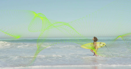Wading woman wearing yellow bikini, carrying yellow surfboard with leash at sandy beach, copy space....