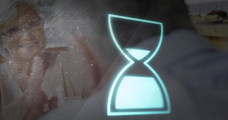 Senior woman raising hand and activating cyan hourglass timer, initiating health reminder, glasses. Couple, indoors, home, glow, overlay, digital, wellnessの写真素材