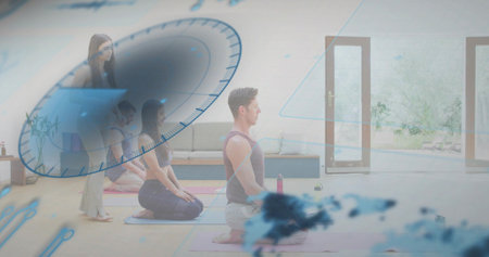 Meditating male kneeling on yoga mat in bright studio, wearing sleeveless top, with digital dial. Mindfulness, serenity, balance, instructor, group, wellness, fitnessの写真素材