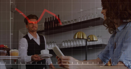 Offering server vest handing cup saucer woman in striped shirt holding white device at cafe overlay....