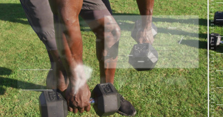 Gripping hex dumbbells, man doing squats on lawn, wearing shorts and black shoes with overlay....