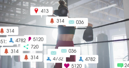 Standing adult boxer wearing sports bra, holding ring ropes in gym showing gloves and social icons....