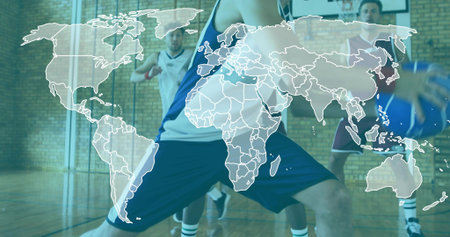 Diverse male players lunging and defending on gym court with basketball, blue and white jerseys....