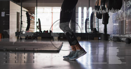 Balancing female exerciser lifting heels in gym wearing dark leggings and gray shoes, HUD overlay....