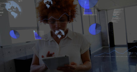 Interacting woman wearing collared shirt holding tablet, viewing blue data charts at office loft....