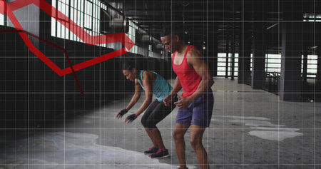 Doing two partners syncing moves in factory, wearing athletic wear with grid and red line chart....