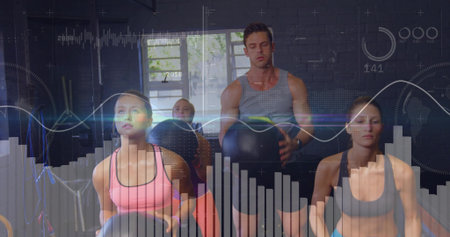 Performing four adults in sportswear holding medicine balls and squatting in gym with HUD. Fitness,...
