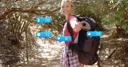 Extending hiker in red top, plaid walking wooded boardwalk with backpack, roll mat, notifications....