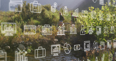 Walking two hikers with backpacks and jackets navigating riverside trail, with white finance icons....