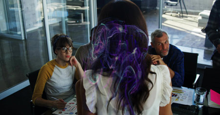Presenting woman in white blouse leading meeting in glass room, showing charts and hologram....