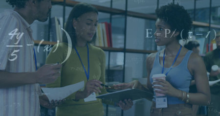 Reviewing documents, three colleagues holding clipboard in office, lanyards and equations overlay. Teamwork, collaboration, meeting, coworking, workplace, data, analyticsの写真素材