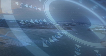 Displaying translucent HUD overlay showing rings, arrows and grid over coastal aerial landscape....