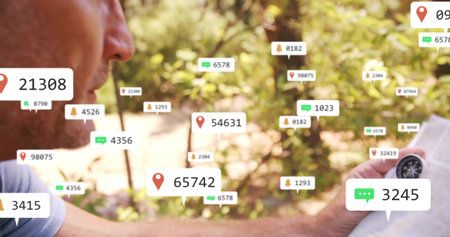 Holding compass mature man lightblue shirt examining map at forest trail with overlays, copy space....