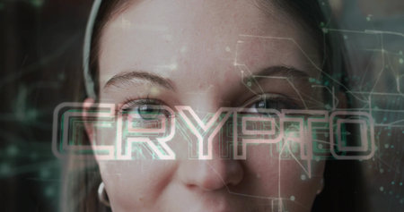 Facing woman gazing toward viewer in studio, with CRYPTO text, network, headband and hoop earring....