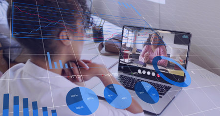 Watching woman wearing white top leaning at home office desk, viewing laptop call with data charts....