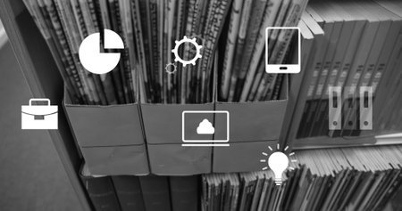 Displaying three cardboard holders with upright magazines on study shelf showing laptop cloud icon....