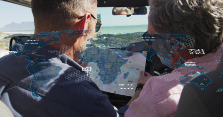 Pointing driver, leaning passenger studying map in car, windshield showing AR overlays, coastline. Navigation, shoreline, beach, ocean, cabin, friends, travel