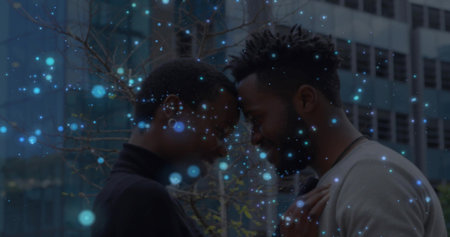 Touching foreheads couple in turtleneck and light sweater at office with bare tree, blue bokeh. Urban, silhouette, intimacy, romance, cityscape, reflections, glass