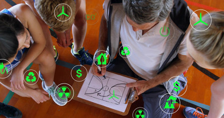 Drawing coach crouching marking school gym clipboard with pen, team in athletic shoes, green icons. Basketball, court, floor, diagram, mentor, youth, training