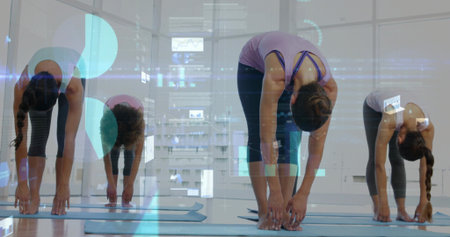 Bending female in purple tank reaching toward floor at fitness studio, with blue mats and HUD. Yoga, group, studio, urban, windows, reflections, overlay