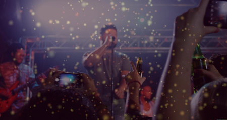 Frontman singing after crowd cheering at music club lights highlighting phones for energizing fans. Vocalist, stage, guitar, microphone, spotlights, haze, confetti