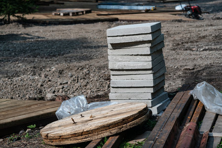 Building materials for the construction of a site in the national park. A stack of concrete tiles, wood and metal structures for landscaping.の写真素材
