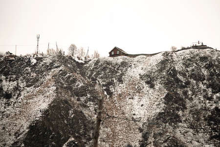 Mountains covered with snow with a dwelling house on the top. Nature in the highlands in winter....