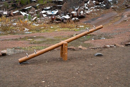 Wooden swing-balancers for children in the national park. Childrens swing in the open air, in the entertainment area.の写真素材