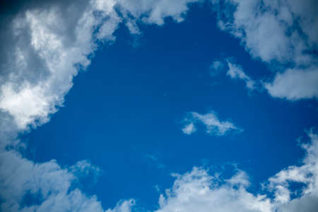 Cumulus clouds in the rays of the evening sun. Clouds against the blue sky. Texture for the...