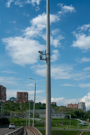 CCTV cameras on a high pillar at the edge of a road bridge. Video surveillance of car traffic on the...