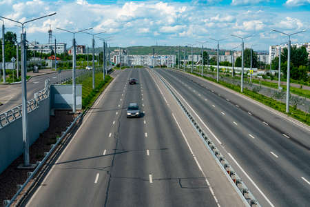 Multi-lane highway with a dividing strip. Busy car traffic on the city highway. Automobile city road...