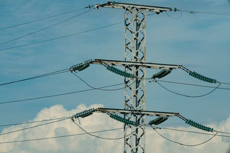 Electric pole against the background of the arch of the railway bridge. Power lines along railway...