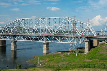 Arch of a railway bridge over a river in an industrial city. Railway bridge with metal profile...
