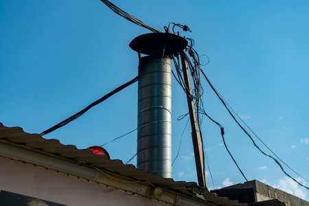 Round tin ventilation pipe on the roof of the house. External ventilation of the dining room kitchen.の写真素材